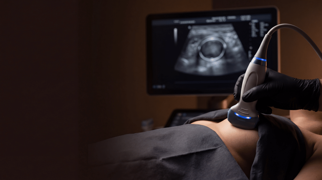 Ultrasound probe scanning a breast implant at Transform Beverly Hills with imaging visible on screen